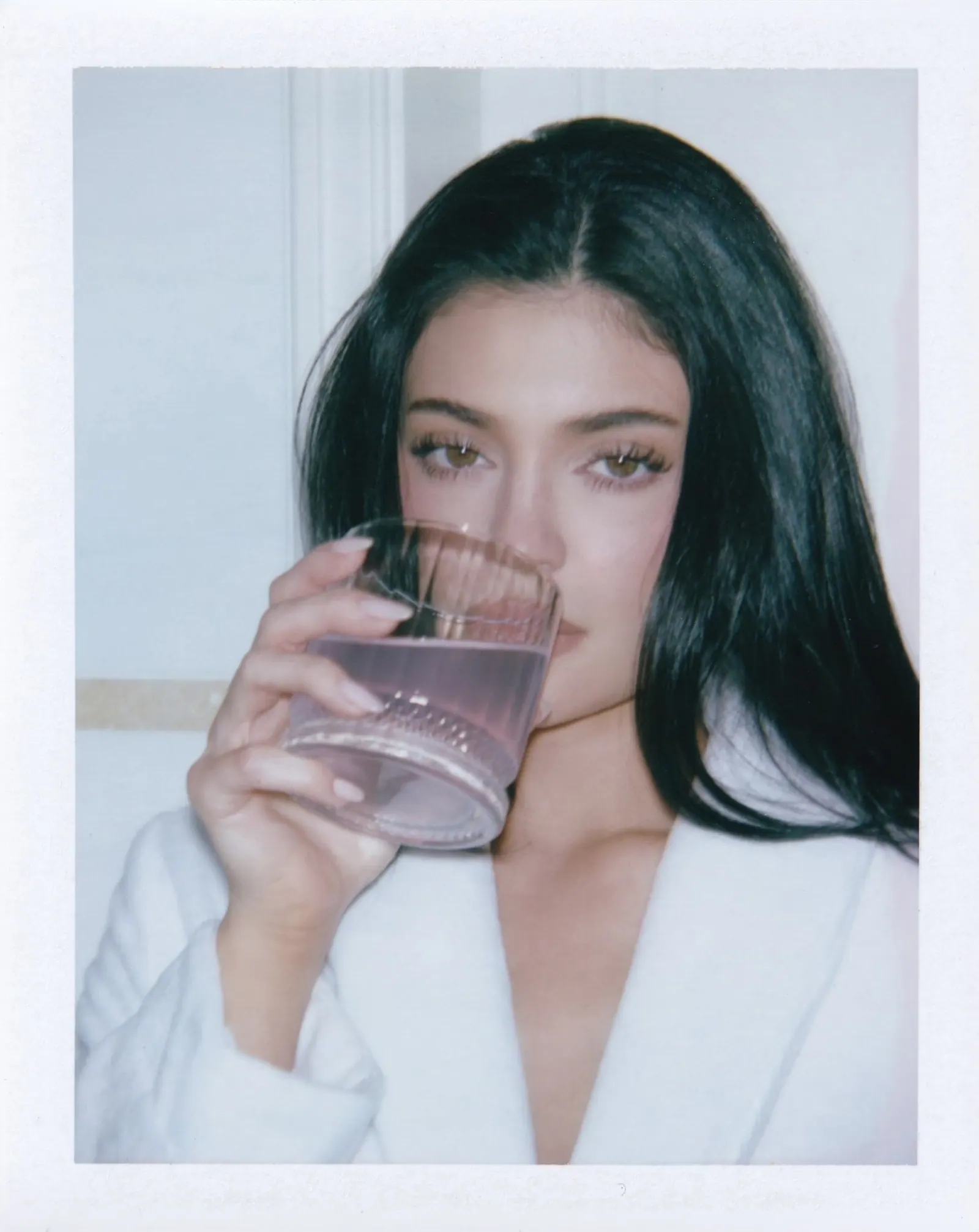 kylie holding a glass of k2o